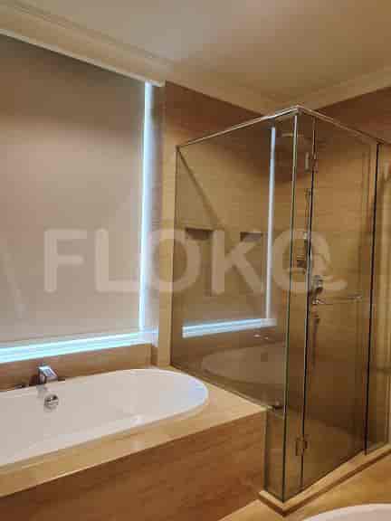 Bathroom featuring a bathtub and a glass shower enclosure.