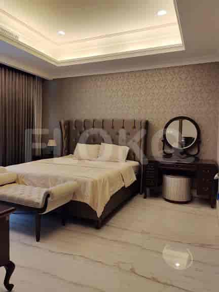 Bedroom with a bed and vanity setup, creating a functional space.