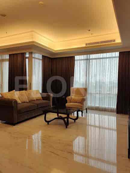 Living room with a sofa and armchair, offering a comfortable seating arrangement.