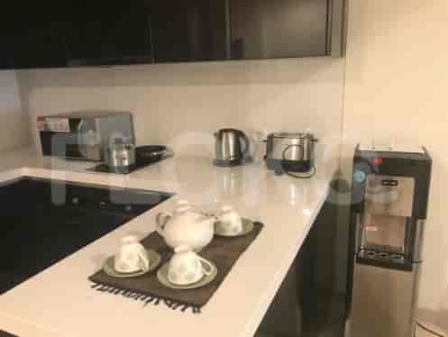 A modern kitchen with appliances, a white countertop, and a water dispenser.