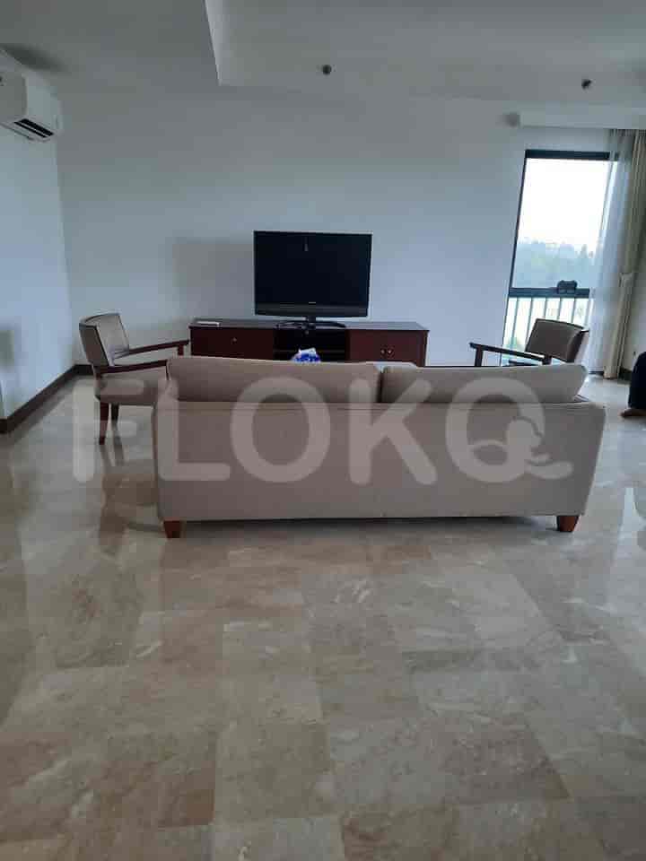 A living room with a sofa, chairs, a TV, and marble flooring.