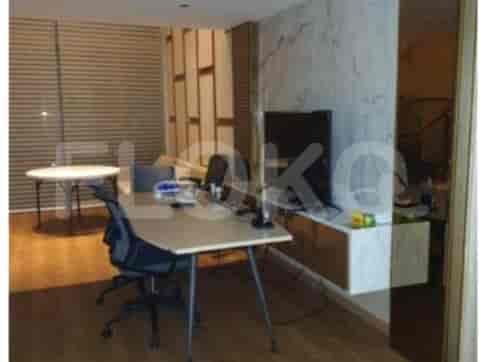 A home office with a desk, office chair, and a window.