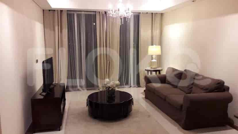 Living room with a sofa, TV, and round coffee table.