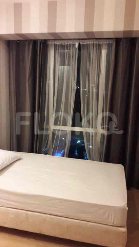 Bedroom with a bed and curtains.