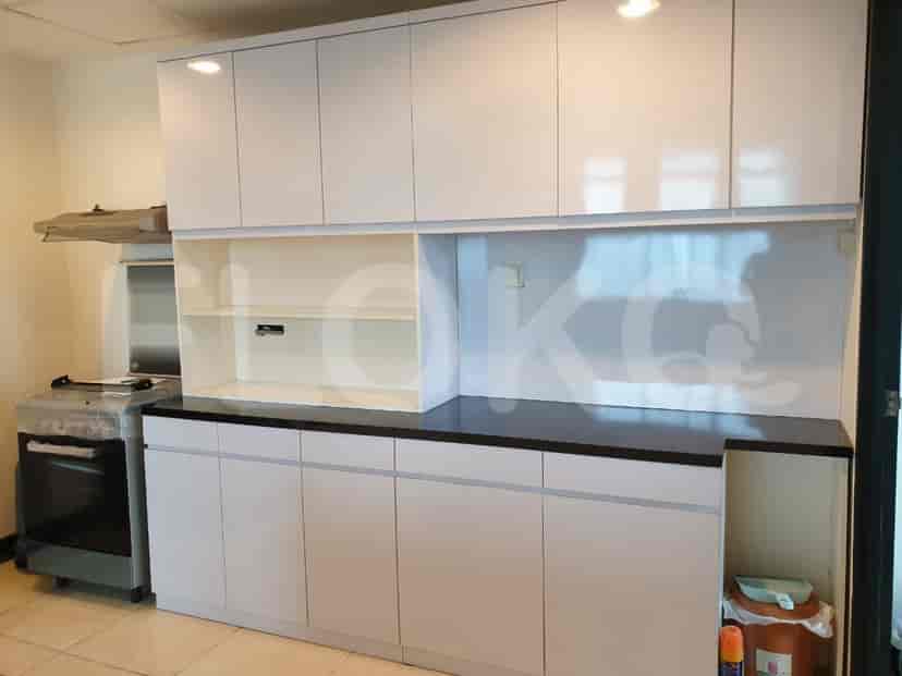 A modern kitchen with white cabinets, dark countertop and stainless steel appliances.