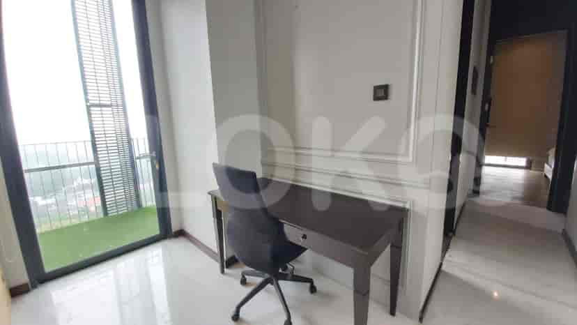 A modern home office setup with a desk, chair, and access to a balcony.