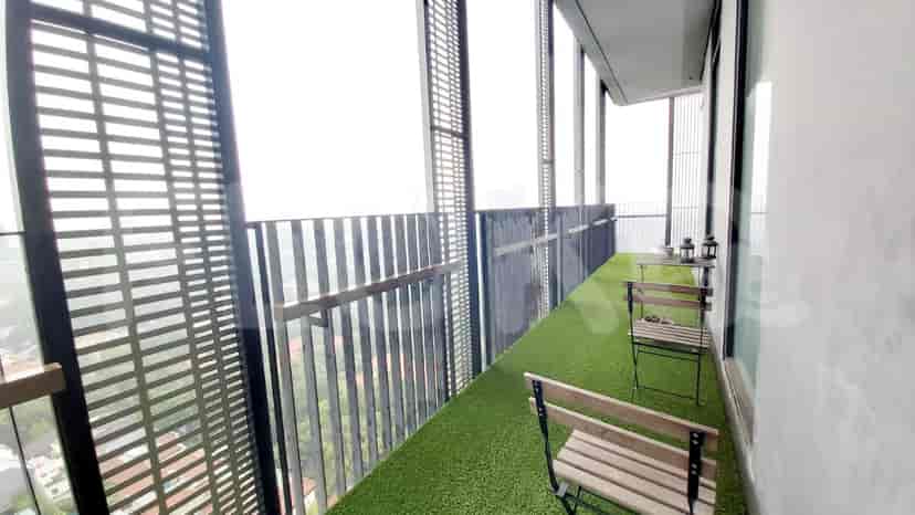 A balcony area with seating and a view of the city.