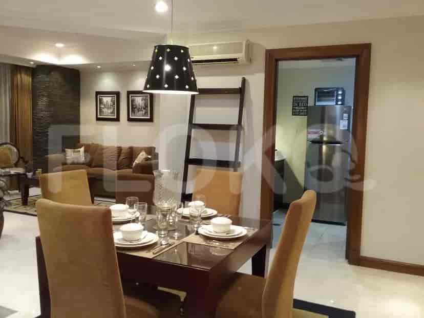 A well-lit dining area, showcasing a modern design and a connection to the kitchen.