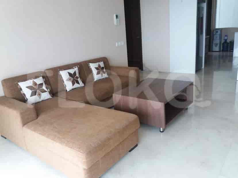 Living room with a sofa, a coffee table and marble flooring.