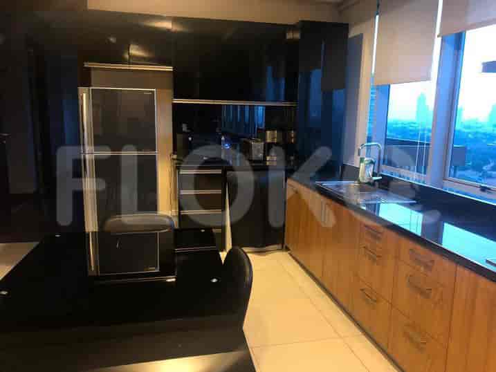 A sleek, modern kitchen with dark cabinetry and stainless steel appliances.
