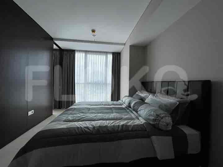 Another bedroom showcasing a queen bed, large windows, and a built-in wardrobe.