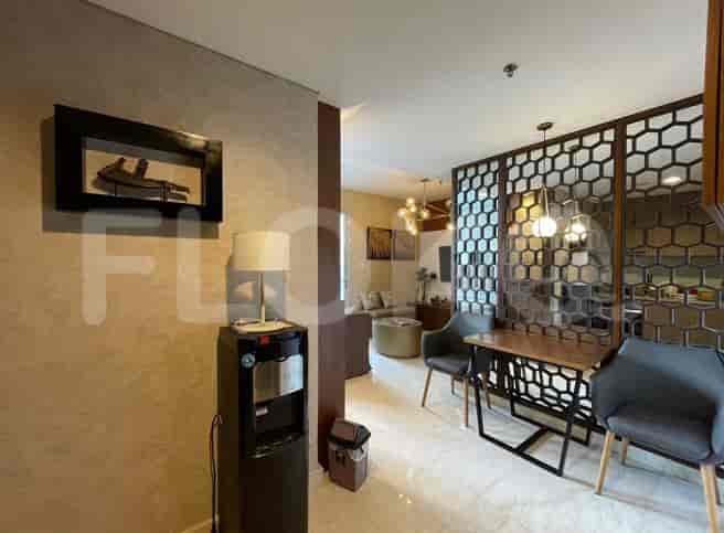 Entrance with water dispenser and dining area with decorative dividers.