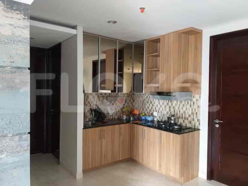 A kitchen with wooden cabinets and a black countertop.