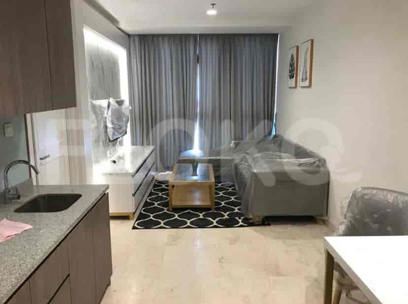 Spacious living area with an L-shaped sofa, coffee table, kitchen, and a view of the city.