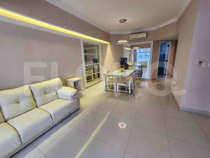 Living area with white sofa, dining table, and neutral color scheme.