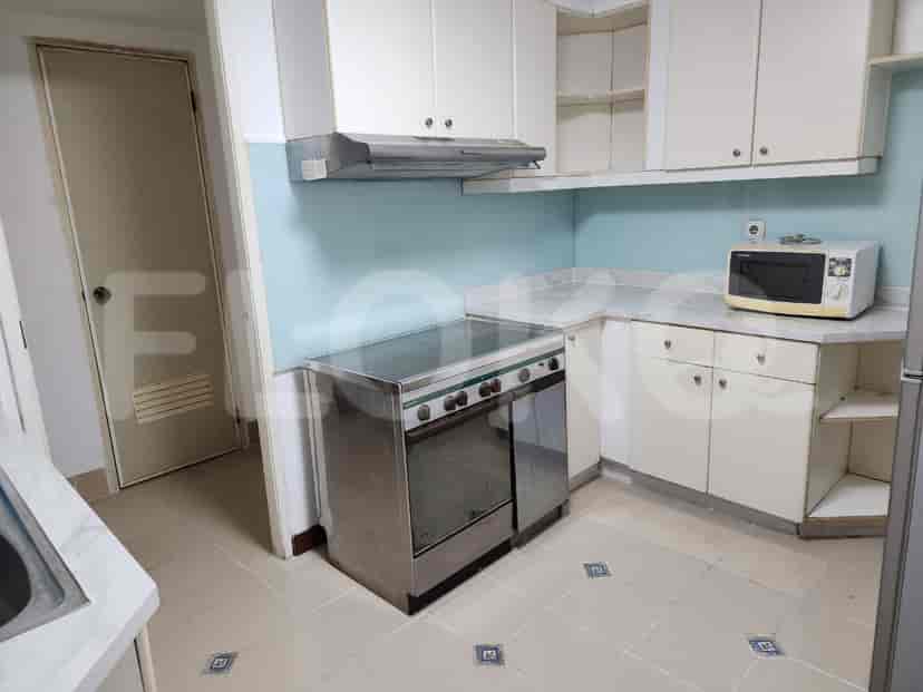 A compact kitchen with white cabinets and essential appliances.