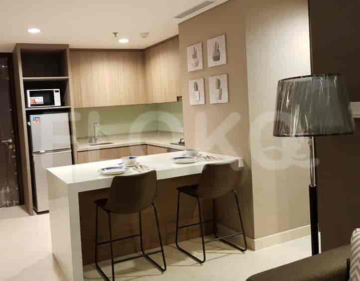 A well-equipped kitchen with a breakfast bar, featuring light-colored cabinetry and a modern aesthetic.