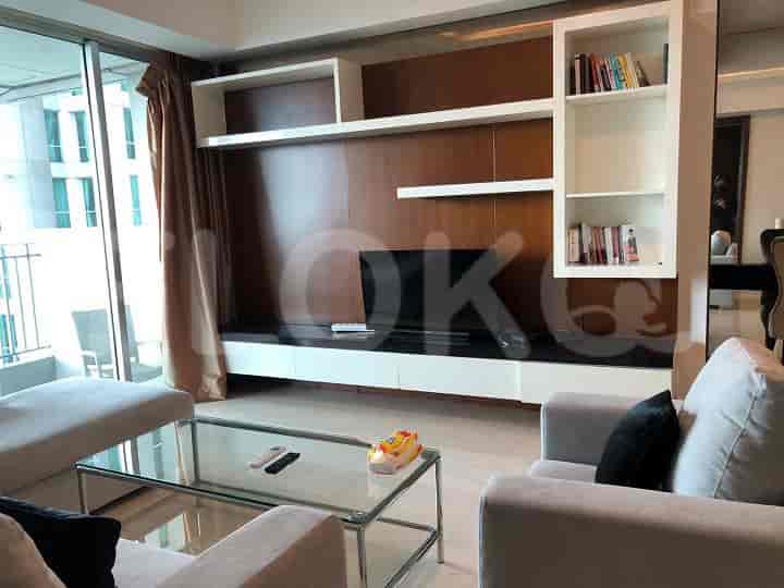 Living room with a TV unit, sofa, and glass coffee table.