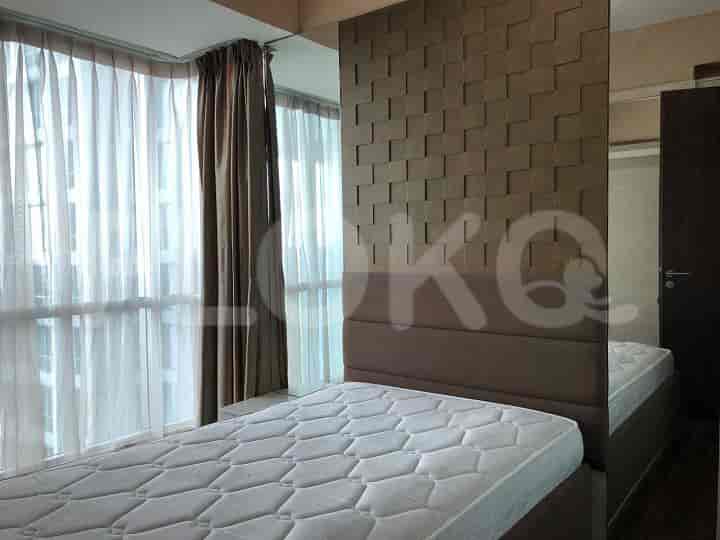 Bedroom with a double bed, and mirrored wall.