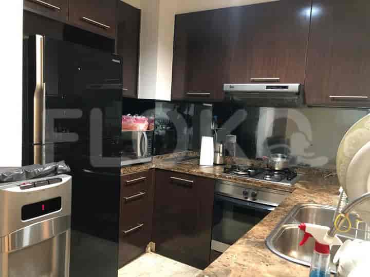 Modern kitchen with dark wood cabinets and stainless steel appliances.