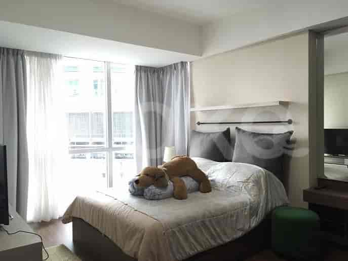 Bedroom with bed, curtains, and plush toy.