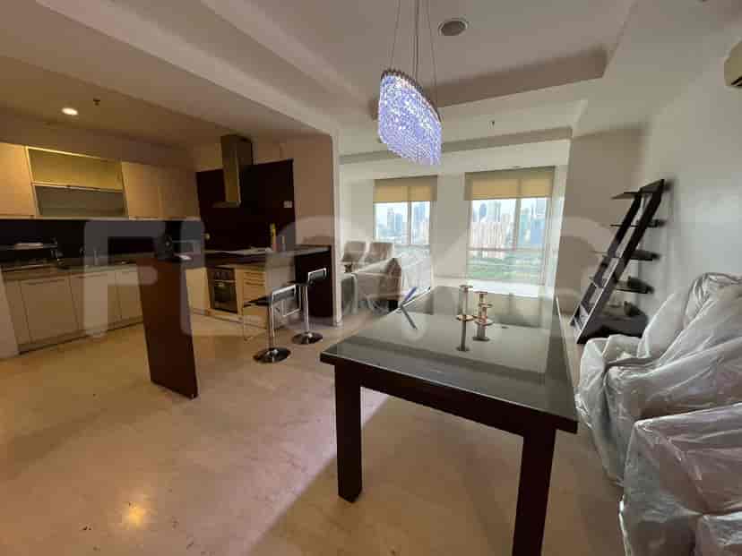 An open-plan kitchen and dining area with a dining table, chairs, and a kitchen island.