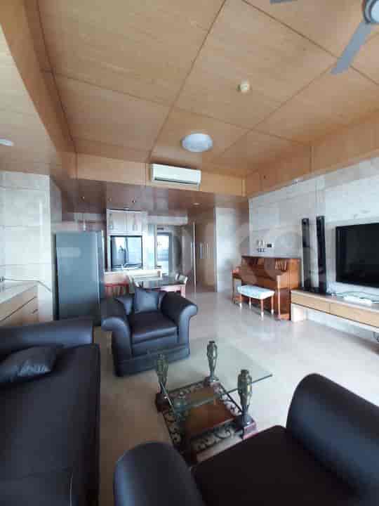Living room with two leather sofas, a glass coffee table, and a grand piano.