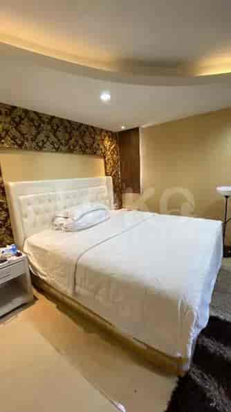 A luxurious bedroom with a large bed and a decorative headboard.