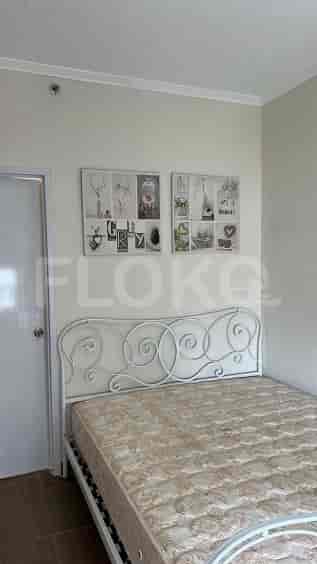 A bedroom with a bed and decorative wall art.