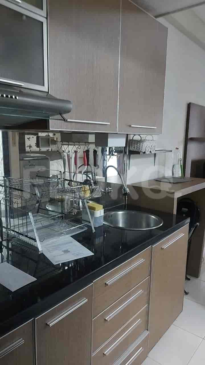Close-up view of the kitchen area with a sink, cabinets, and countertop.
