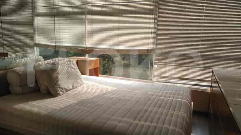 Bedroom with bed, window, and blinds.
