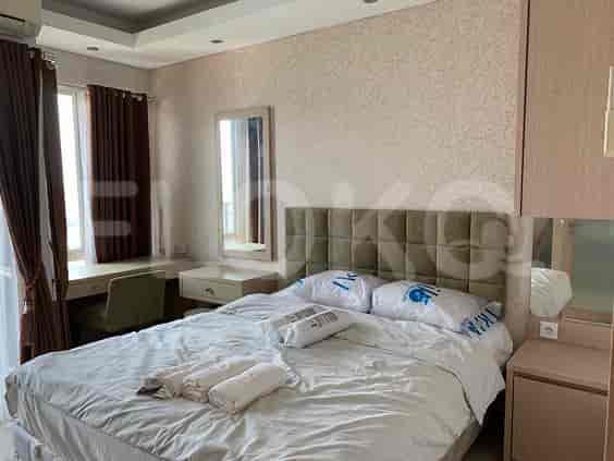Bedroom with a double bed, curtains, and a dressing table.