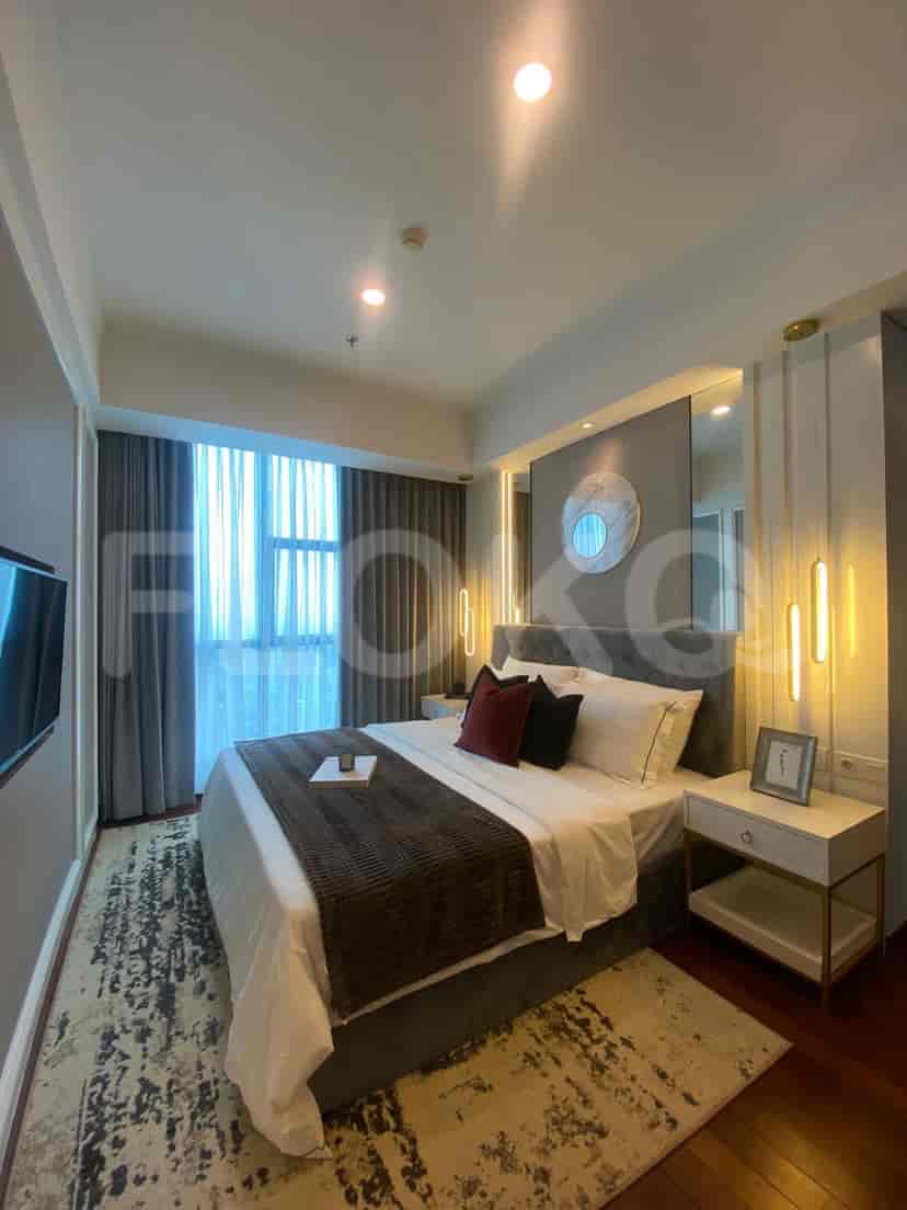 A master bedroom with a large bed, accent lighting, and stylish decor.