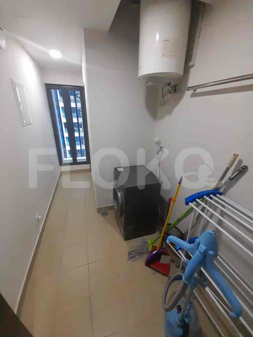 Laundry room with washing machine and drying rack.