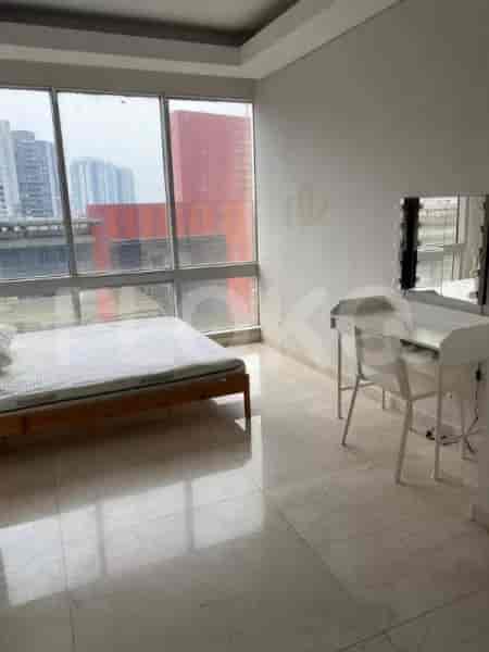 Bedroom with a bed, a desk with mirror, and a city view.