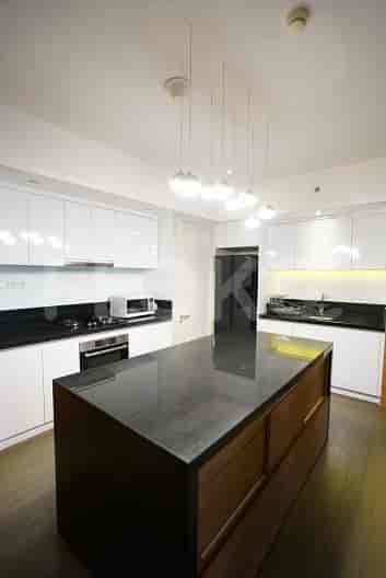 A modern kitchen with white cabinets, an island, and contemporary appliances.