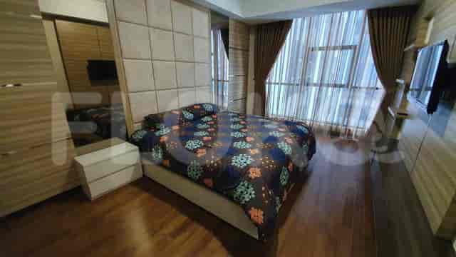 Bedroom with a king-size bed, large windows, and modern decor.