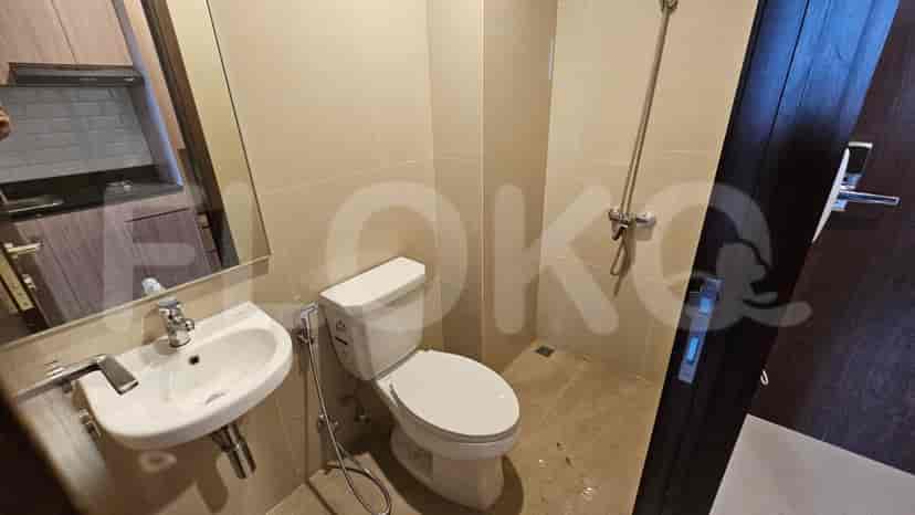 Bathroom with a toilet, sink, and a shower area.