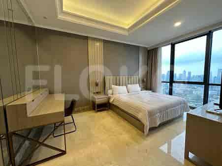Elegant bedroom featuring a king-sized bed, desk, and city views.