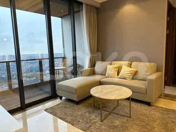 Modern living area with a sectional sofa, round coffee table, and city view.