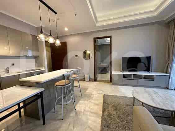 Open-plan living and kitchen area with a breakfast bar and pendant lights.