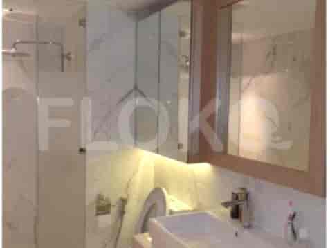 A bathroom with a sink, vanity, and shower area.