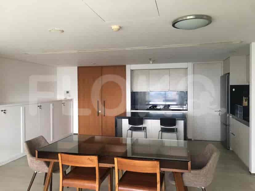 An open kitchen and dining area with modern appliances and sleek design.