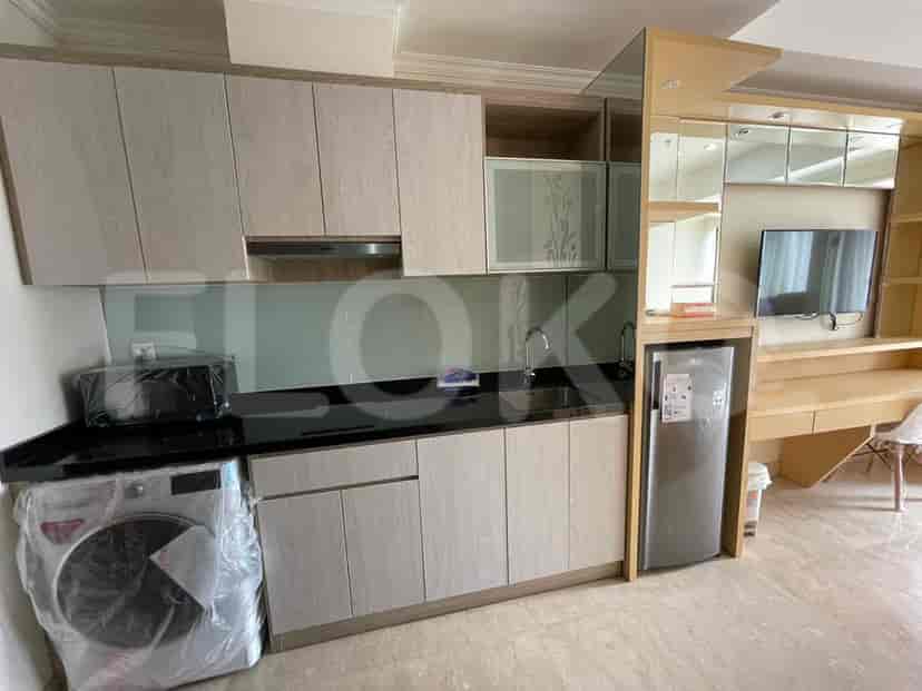 A close-up of a kitchenette area with appliances and cabinets.