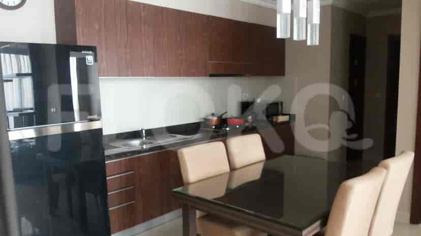 Kitchen and dining area with table set and cabinets.