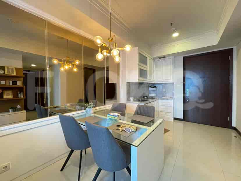 A modern kitchen with white cabinets and appliances.