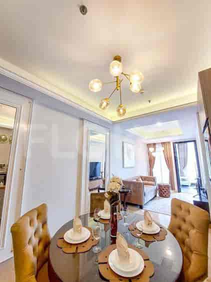 Dining area with a round table and chandelier.
