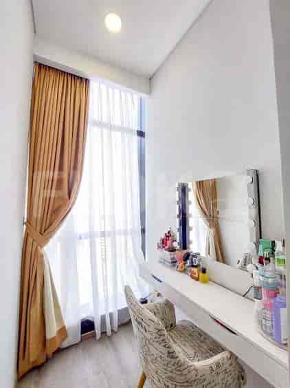 Vanity area with a mirror, curtains, and chair.
