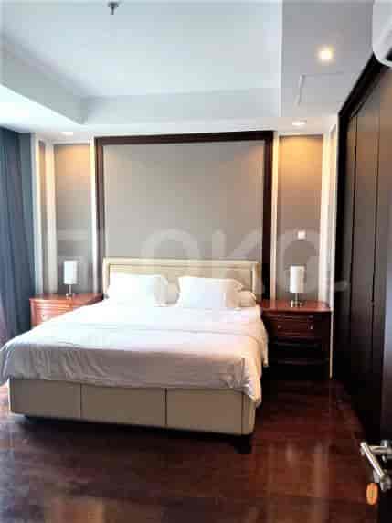 Another view of the bedroom with a king-sized bed and closet.