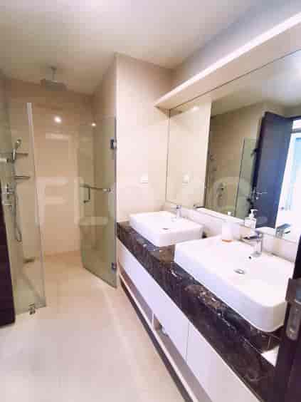 Spacious bathroom with double sinks, a glass shower, and a large mirror.